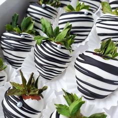 chocolate covered strawberries with black and white stripes are arranged in the shape of strawberrys