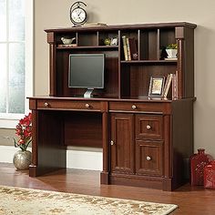 a wooden desk with a computer on top of it