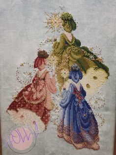 two cross stitched pictures of women in dresses