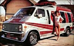 a woman standing next to an old van