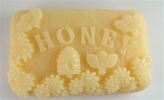 a soap bar with honey written on it and flowers around the edge that says honey