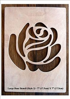 a wooden plaque with a rose on it