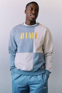 a young man wearing a blue and white sweatshirt with the word fame printed on it