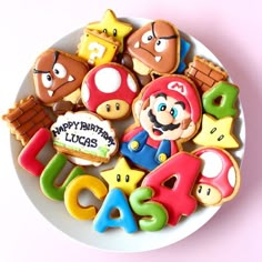 a plate full of cookies decorated like mario and other characters