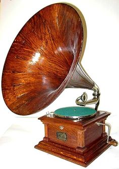 an old fashioned wooden record player on a white background