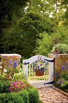 a garden gate with flowers and plants growing on it