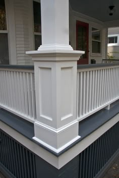 the front porch is painted white and has black trim