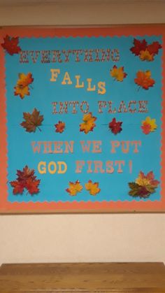 a bulletin board with fall leaves on it and the words, everything falls into place when we put god first