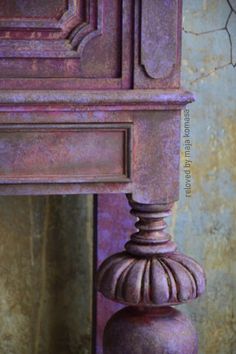 an old purple wooden table with a mirror in the background