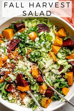 a white bowl filled with salad topped with lettuce, carrots and feta cheese