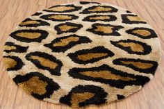 an animal print rug on the floor with wood floors in the background and a hard wood floor