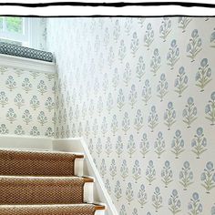 a stair case with floral wallpaper on it