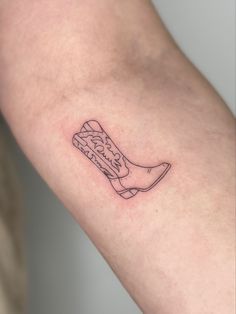 a small tattoo on the arm of a person's leg with a boot in it