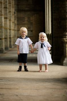 Our timeless boys or girls linen sailor suit is a true British classic,  perfect for a beach wedding either for a ring bearer or just a special guest.  Linen is traditionally a very appropriate fabric choice for christening, baptism or holy communion outfits.  -Traditional sailor suit -Sailor shirt created in white Irish linen and a thicker navy linen collar and shorts -Collar trimmed with cotton ribbon -Navy linen flat  fronted waistband with an elasticated back -Lined shorts with Liberty Tana Sailor Outfit, Nautical Outfits, Sailor Shirt, Navy Sailor, Sailor Suit, Sailor Dress, Navy Linen, Linen Suit