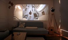 a living room filled with furniture and a projector