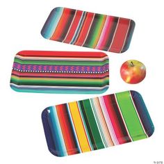 three placemats and an apple on a white background with multicolored stripes