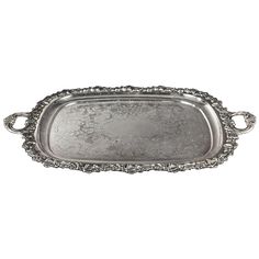 an ornate silver tray with handles