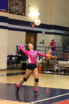 a female volleyball player in action on the court