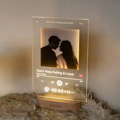 an illuminated photo frame with a couple kissing in front of the screen and sound waves