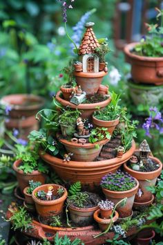 there are many potted plants in the shape of a house on top of each other