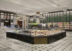 a restaurant filled with lots of food on top of a tiled floor next to windows