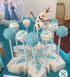 there are some cake pops that have been made to look like the characters from disney's frozen world