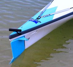 a blue and white kayak sitting in the water