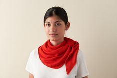 a woman wearing a white shirt and red scarf