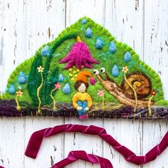 a handmade felt headband with an animal scene on it