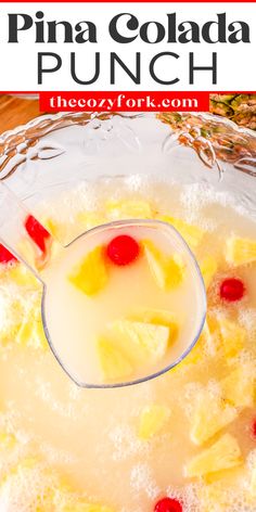 pineapple punch in a glass bowl with ice and cherries on the rim text overlay reads pina colada punch