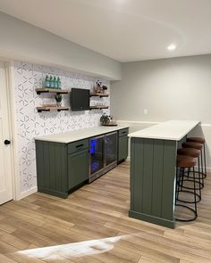 a kitchen with white counter tops and green cabinets