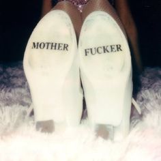 two pairs of white shoes with the words mother and focker written on them