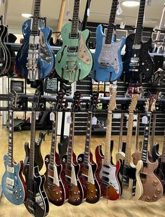 many guitars are on display in a music store