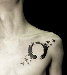 a man's chest with birds flying around it and the letter o on his chest