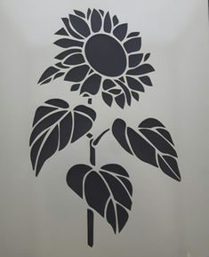 a large sunflower is on the side of a wall