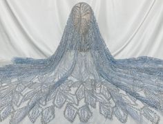 the back of a blue wedding dress on display