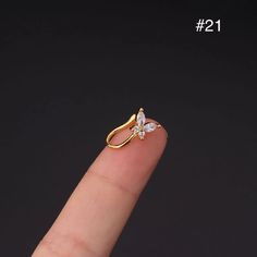 a person's finger with a gold ring on it and the number one in front