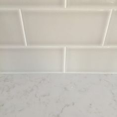 a white tile backsplash in a bathroom