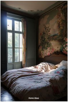 an unmade bed sitting in front of a window