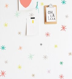 a white wall with colorful stars and hearts on it