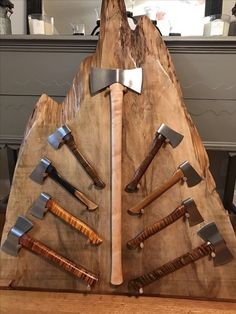 a wooden sculpture with many different types of knives on it