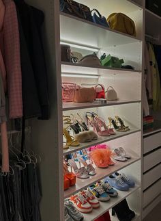 a closet filled with lots of shoes and handbags