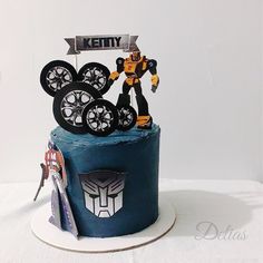 a birthday cake with an iron man figure on top