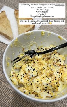 a white bowl filled with food next to a slice of bread