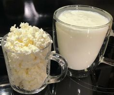 a glass mug filled with milk next to a cup full of cottage cheese