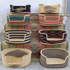 woven baskets stacked on top of each other in different colors and sizes, all lined up together