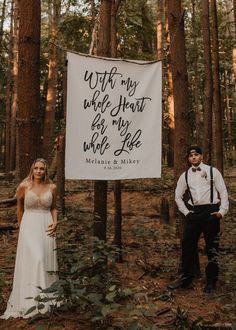 a man and woman standing in the woods next to a sign that says, if my whole heart for my whole life