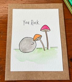 a card with an image of two mushrooms and the words you rock written on it