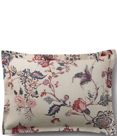 a white pillow with red and blue flowers on it