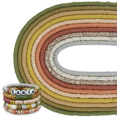 multicolored woven bracelets are arranged in an oval pattern with the word love on them